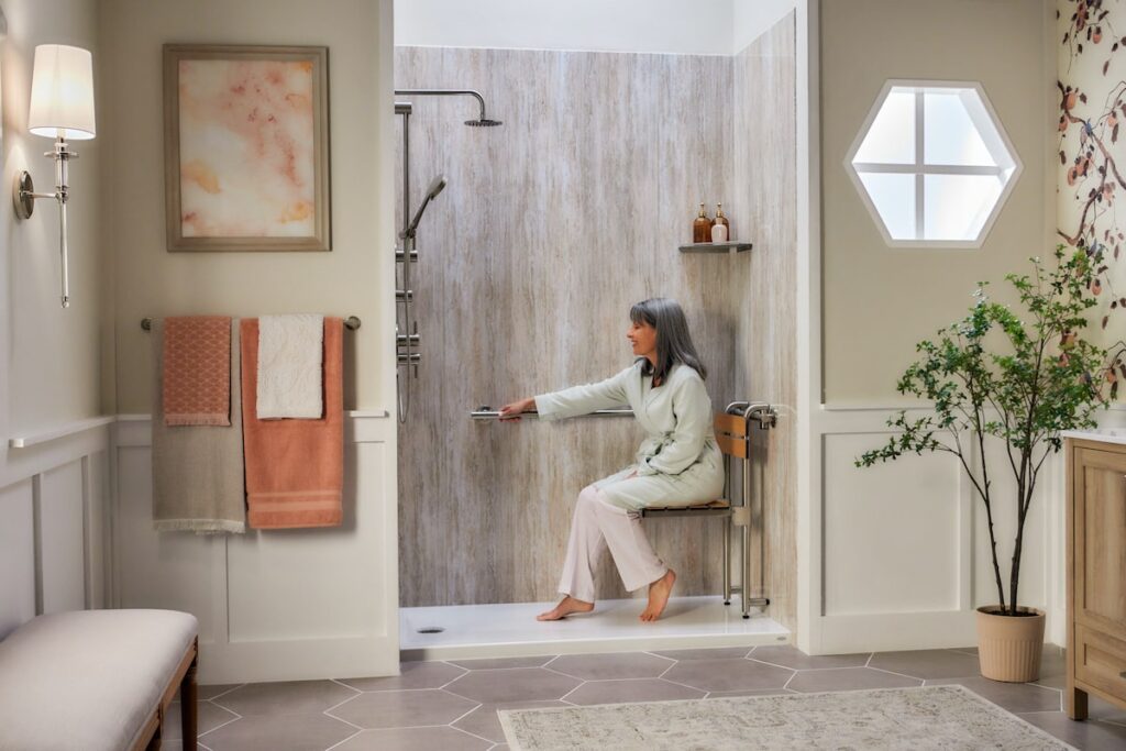 Elderly woman sitting in her walk-in shower