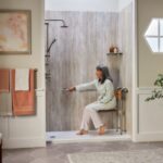 Elderly woman sitting in her walk-in shower